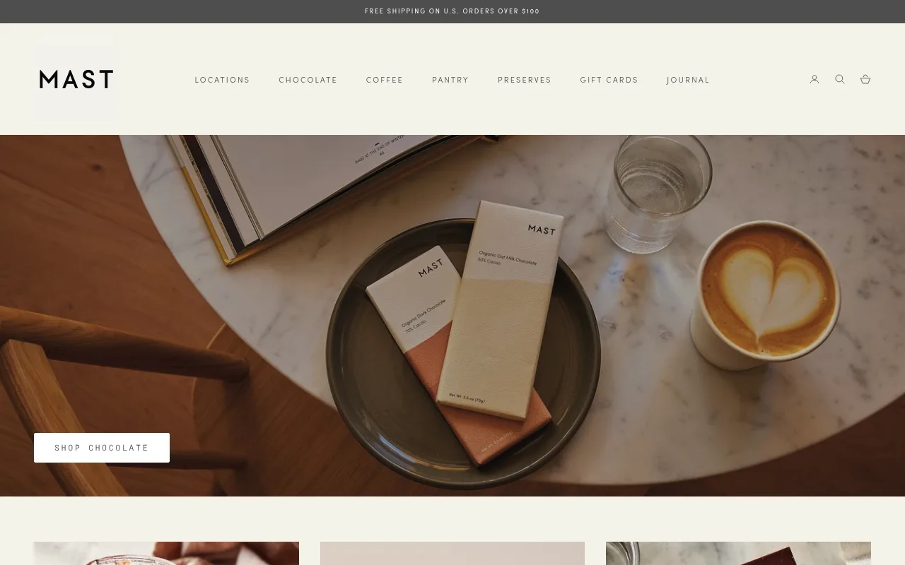 Mast homepage showing minimal chocolate bar packaging next to a coffee on a marble table