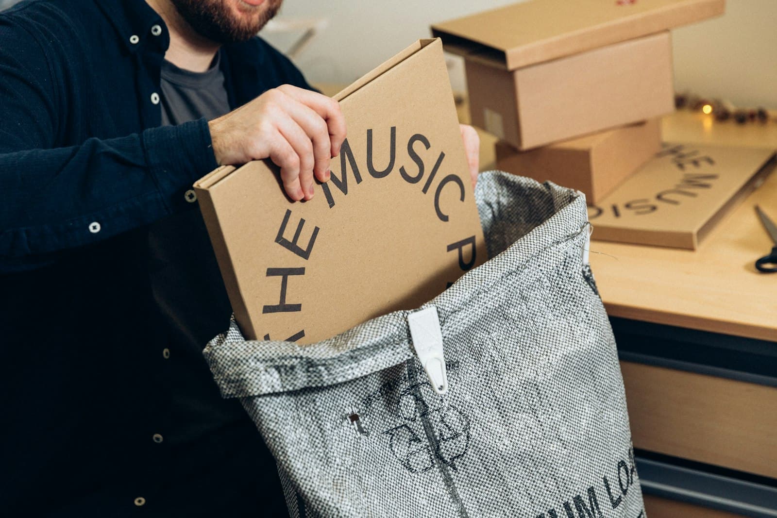 A small-business owner packing an order at home, the reality of the first hundred shipments for most online stores