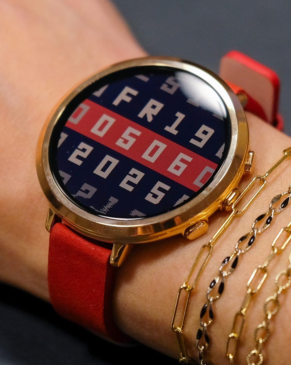 Pebble Round 2 with a red strap on a wrist